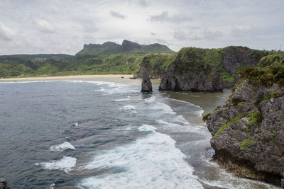 Scenic view of sea and mountains against sky