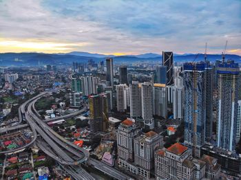 High angle view of modern buildings in city against sky