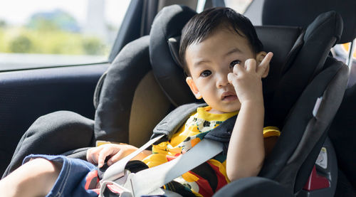 Portrait of cute girl sitting in car