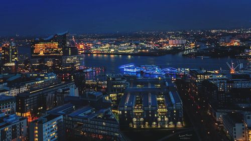 Aerial view of illuminated city at night