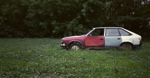 Abandoned car on field