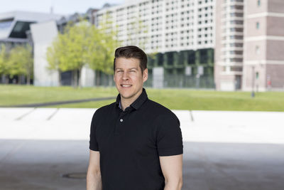 Portrait of mature man standing in city