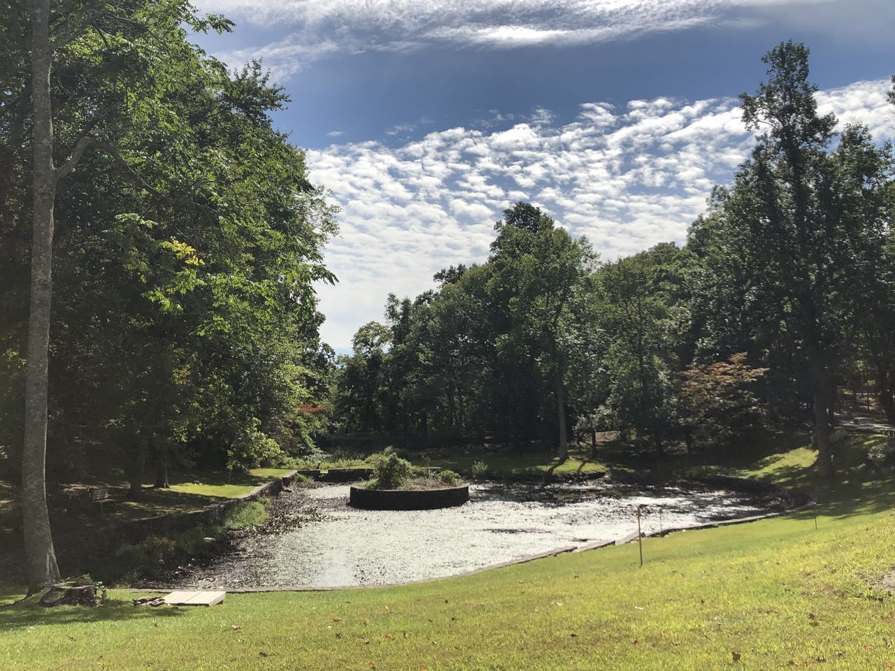 SCENIC VIEW OF WATERFALL AGAINST SKY