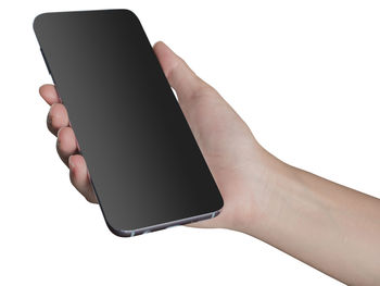 Close-up of hand holding smart phone against white background