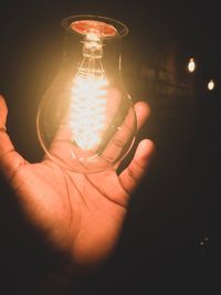 Close-up of hand holding light bulb