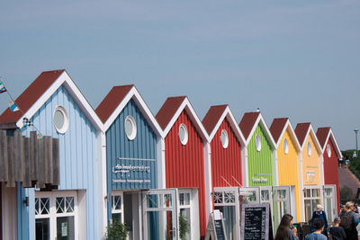 Multi colored houses in city against sky