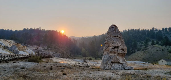 Scenic view of snow covered land against sky during sunset