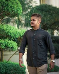 Portrait of young man standing outdoors