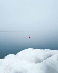 Scenic view of sea against clear sky during winter