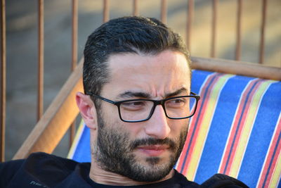 Close-up of man looking away while wearing eyeglasses