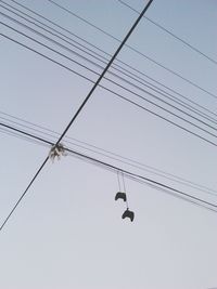 Low angle view of birds flying against sky