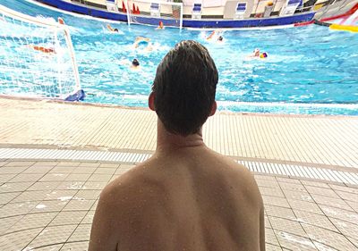 Rear view of man standing by sea