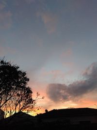 Low angle view of silhouette trees against sky at sunset