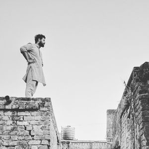 Low angle view of man against clear sky