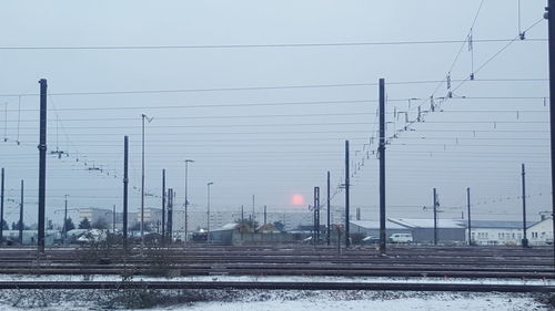 Railway tracks against clear sky during winter