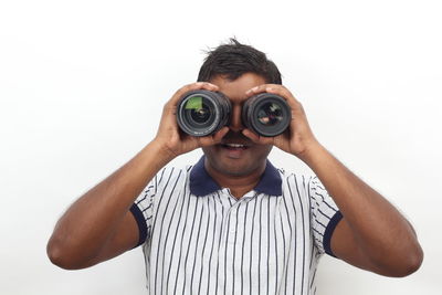 Man holding camera against white background