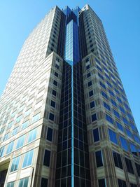 Low angle view of skyscrapers against clear blue sky