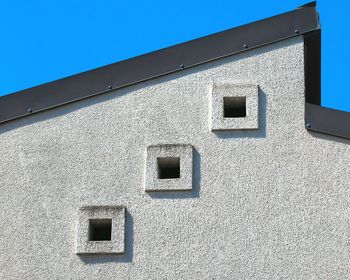 Low angle view of building against clear blue sky