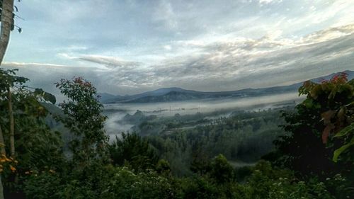 Scenic view of mountains against cloudy sky