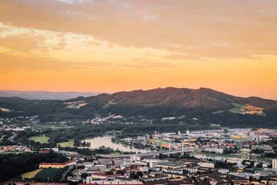 Sunset falls on city of linz in northern austria. beautiful orange sky and the eastern part of city.