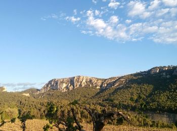 Scenic view of mountains against cloudy sky