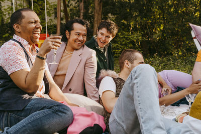 Cheerful friends from lgbtq community having fun during party in back yard