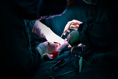 Surgeons performing surgery on patient at hospital