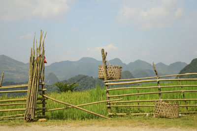 Fence on field against sky