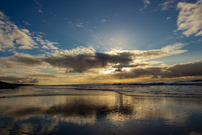 View of sea against cloudy sky during sunset