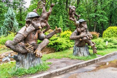 Statue amidst trees in forest