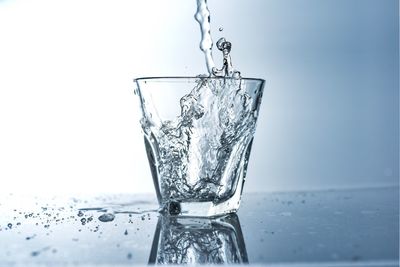 Close-up of water splashing against white background