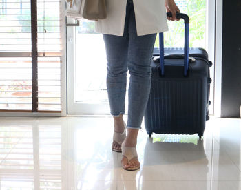 Low section of woman standing on tiled floor