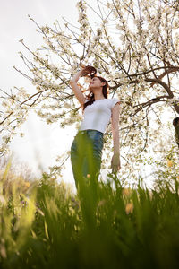 Young woman standing amidst plants