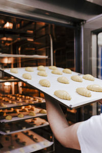 Cropped hands preparing pastry in bakery