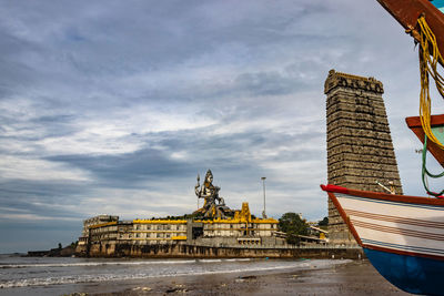 Statue of buildings against cloudy sky