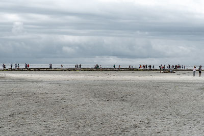 People on beach against sky