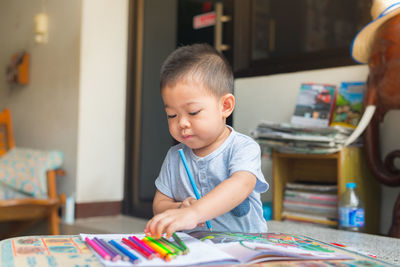 Boy drawing on table at home