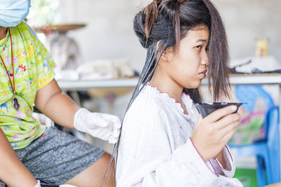 Hairdresser applies a hair mask to the woman in the beauty salon. botox and keratin hair 