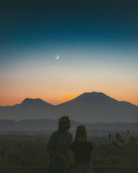 Scenic view of mountains against sky at sunset