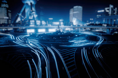 Aerial view of illuminated buildings in city at night