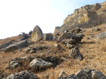 Rock formations on landscape against sky