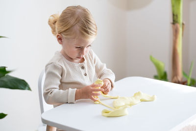 Boy playing with food on table