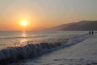 Scenic view of sea against clear sky during sunset