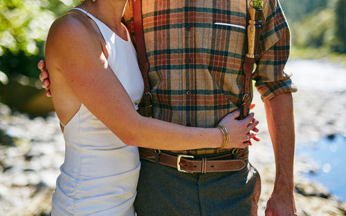 Midsection of couple holding hands