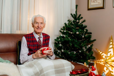 Portrait of young man with christmas tree