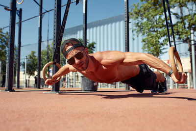 Low section of woman exercising on street