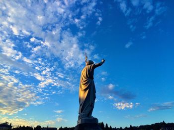 Low angle view of statue against cloudy sky