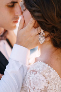 Bride and groom embracing outdoors