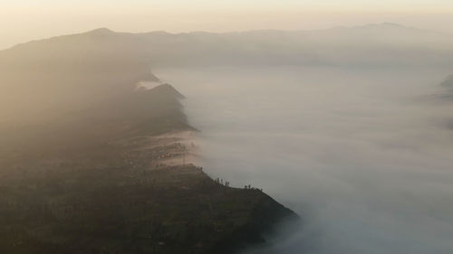 Scenic view of sea and mountains against sky