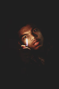 Portrait of young man in darkroom